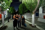 Greece, North Aegean,Fournoi, Kambos:The main road  is full of mulberries and leads to the square. Flitzani family (l) and 85year old Evdokia Ahladi (r) love their island and keep it alive for their grandchildren
 © Maro Kouri
