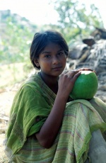India,Puttaparthi village near Sai Baba‘s Ashram. Twelve year old Leem sits in a coconut plantation.  © Maro Kouri