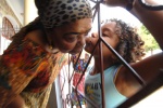 Cezaria Evora outside her house where children come to give her a kiss. All her compatriots love her, as she use to help them in many ways, for example by lending them money and never asking it back. Mindelo, Cape Verde
 © Maro Kouri