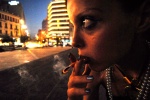 Athens: 22-year old Popi scores her ‘junk‘ every evening in the central Omonoia square. Lack of heroin might stop her two months pregnancy, so, her doctor insists just to reduce it. Opium substance burns at her cigarette. © Maro Kouri