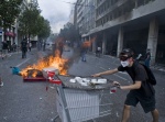 Riots during a rally against plans for new austerity measures///Protestor with stones and fire against the riot police who trought tear gas at Parliament square
 © Maro Kouri