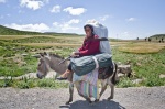 Woman traditional dressed with suitcase on a donkey
 © Maro Kouri