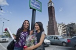 Youn women with flowers in the renamed clock square at the end of Av. Borguiba. ‘‘January, 14, 2011‘‘ is the day of Ben Ali fall
 © Maro Kouri