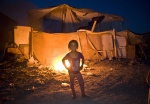 July 5, 2011-Athens. Greece : A Roma girl burns garbage in the shantytown of Botanikos
 © Maro Kouri