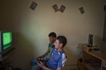 Young men in an empty play station cafe of Redeyef
 © Maro Kouri