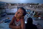 July 5, 2011 - Botanikos, Athens, Greece: Roma little boy who left school to work in the squatter ship of central Athens, is dreaming of a toy. Shantytown in the background
 © Maro Kouri