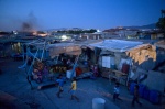 July 5, 2011-Botanikos, Athens, Greece: A smoke emerges in to the Roma shantytown from the burning cables and other metal trash and children run playing …

 © Maro Kouri