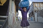 October 22, 2011 -Athens, Greece:10 years old Zosefine carries a plastic bag with toys that she collected from the streets and garbage. Zosefine, was born in Botanikos Roma‘ township after the arrival of her parents from the Albanian gypsy-city El Basan.
 © Maro Kouri